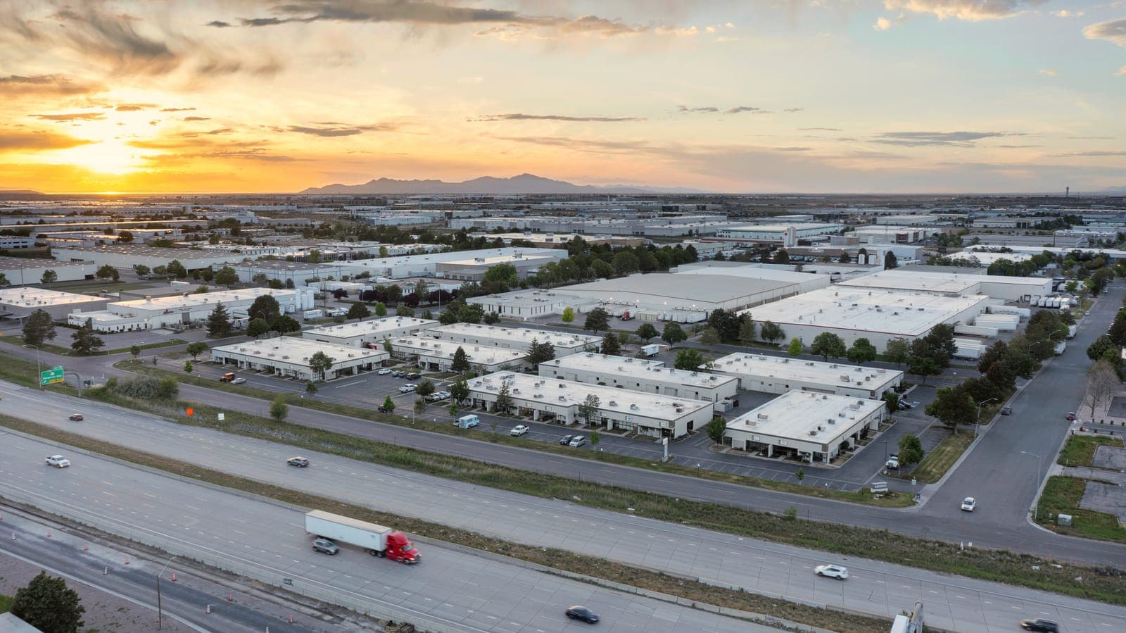 Sunset aerial drone view over Broadbent Business Park and the Salt Lake Valley industrial corridor